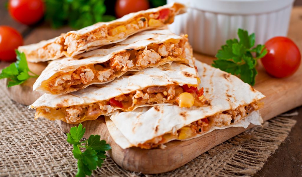 Mexican Quesadilla wrap with chicken, corn and sweet pepper and salsa